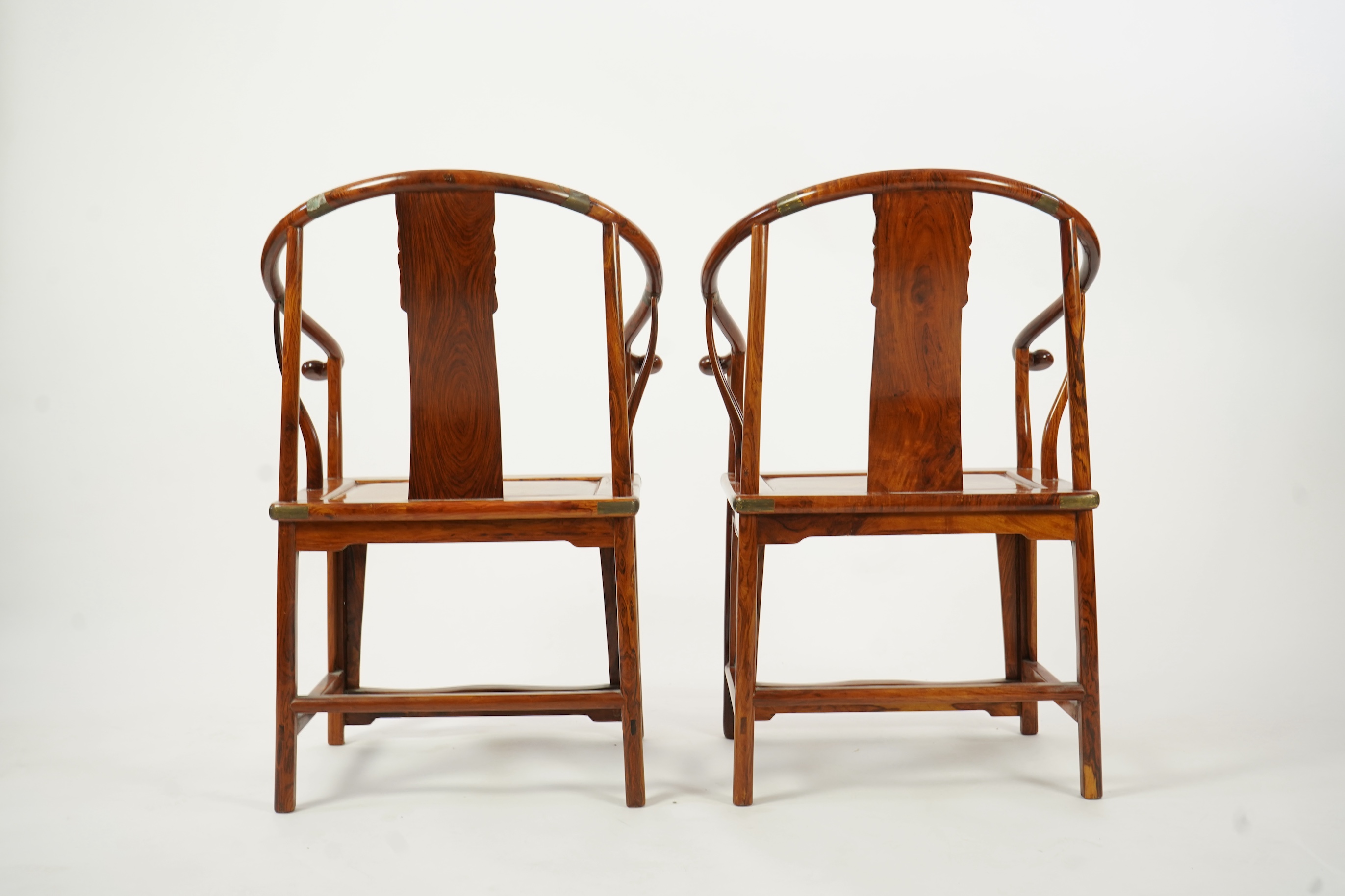 A pair of Chinese huanghuali and brass mounted horseshoe-back armchairs, quanyi, 19th century
